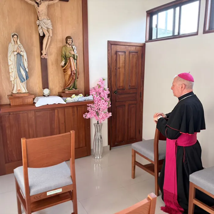 The Apostolic Nuncio prays at the altar