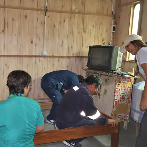 Workers inside of the barrio setting up the living space.