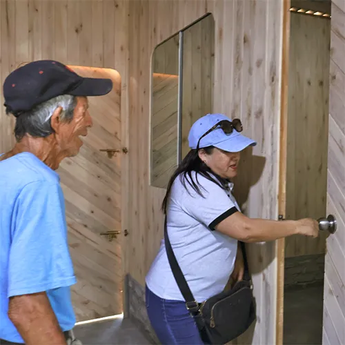 Social worker with brother inside new home