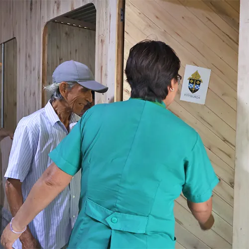 Social worker with brother inside new home