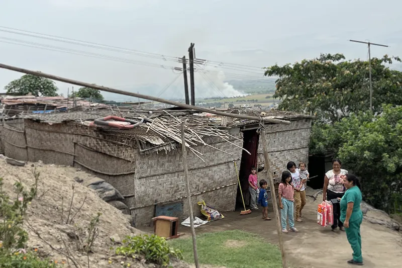 Family and nurse at thatched home