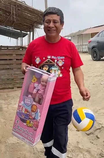 May God bless you during this holiday season. Feliz Navidad! Chimbote man smiling with gifts to deliver