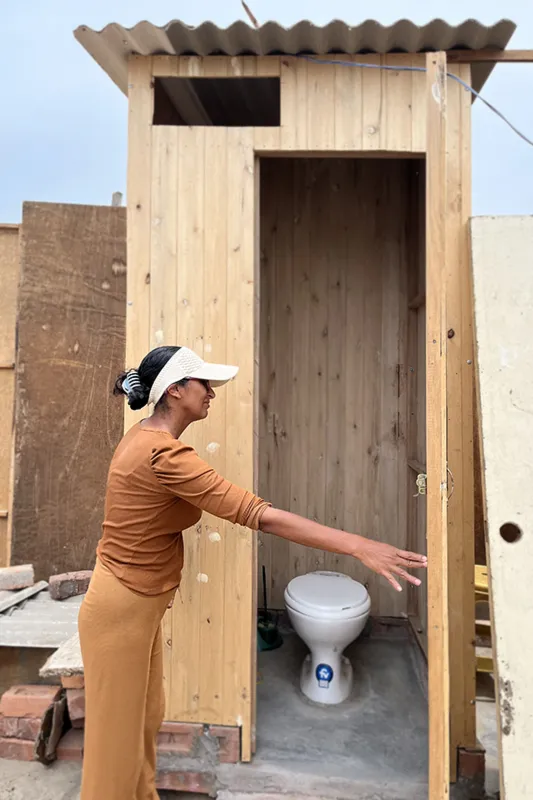 Woman showing new latrine